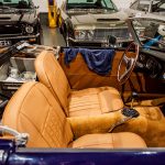 The camel interior of a dark blue classic MG cabriolet